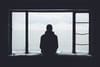 Man staring through window.