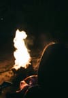 Woman watching fire.